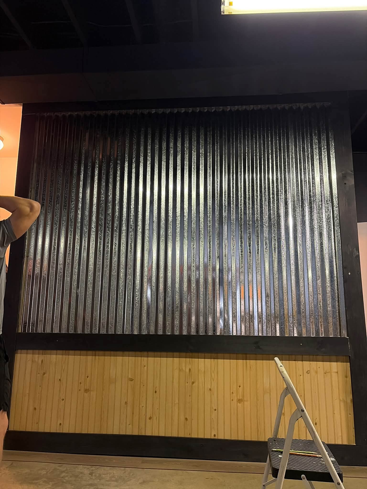 Close-up of a corrugated metal and pine accent wall