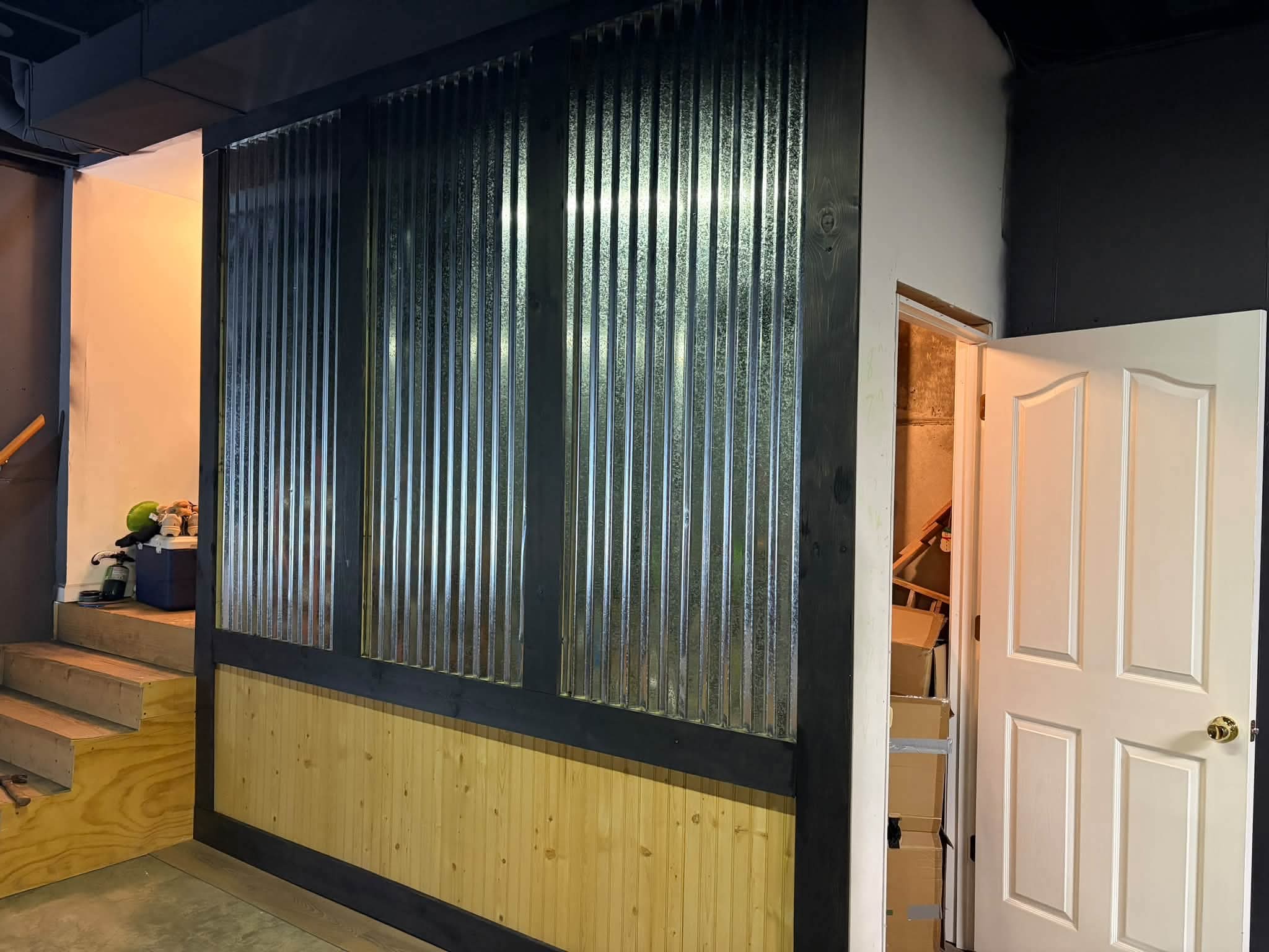 Corrugated metal and pine accent wall with a black frame